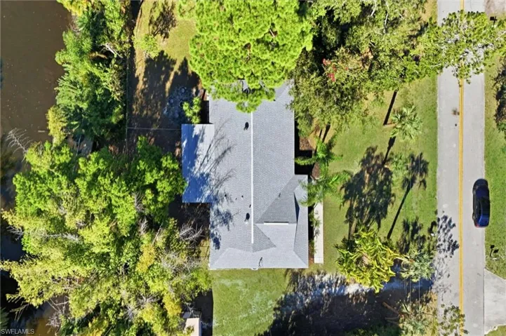An Aerial view of the Home that sits on the water with .56 Acres of land!
