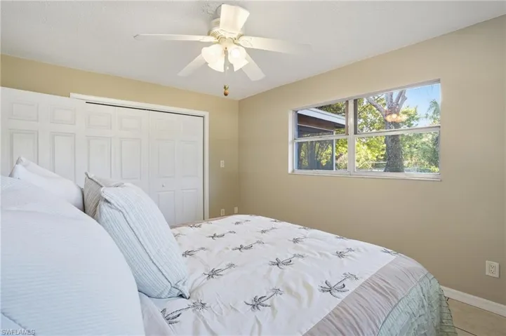 Guest Bedroom #1 features plenty of closet space, natural lighting & views of the expansive backyard, Canal & Boat Dock.