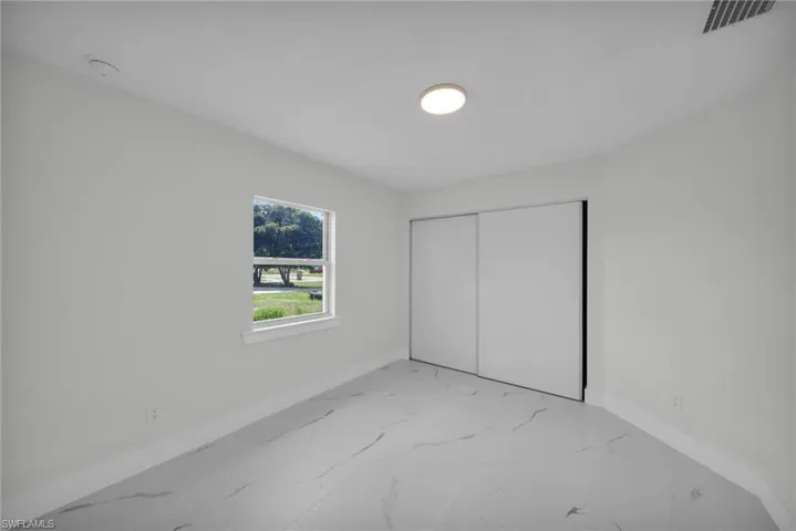 Bright room with white walls, white baseboards, and a single window