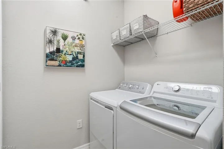 Laundry room with washing machine and clothes dryer