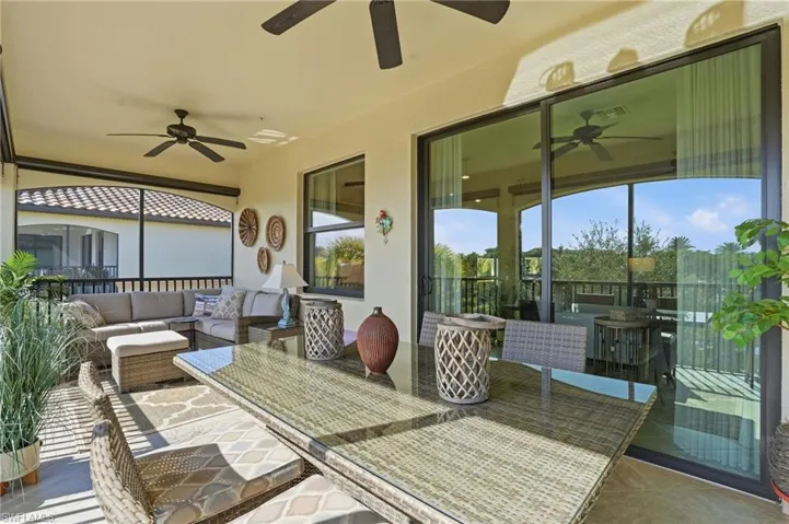 View of patio with ceiling fan, an outdoor living space, a sunroom, and outdoor dining space