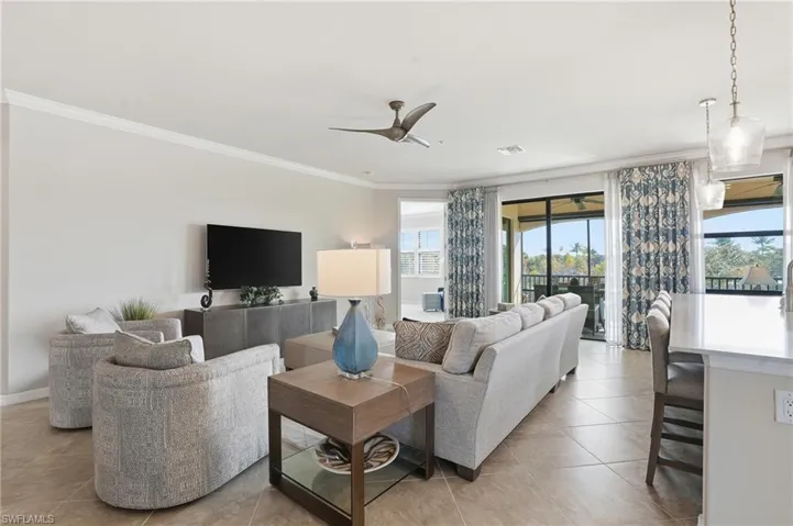 Large living room offering seamless flow to the primary suite and picturesque lanai views.