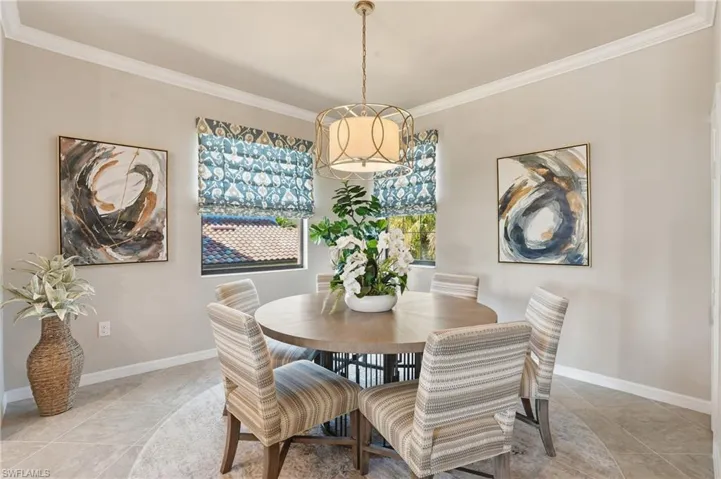 Light-filled dining space featuring soft neutral colors and a timeless chandelier for formal or informal dining.