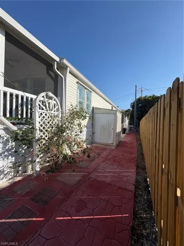 PAVERED WALKWAY RUNS ALONG THE ENTIRE SIDE TO THE DRIVEWAY WITH A LARGE STORAGE SHED