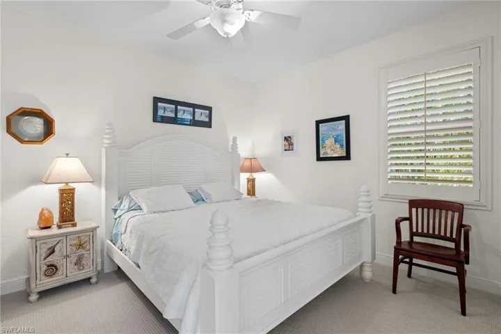 Carpeted bedroom with ceiling fan