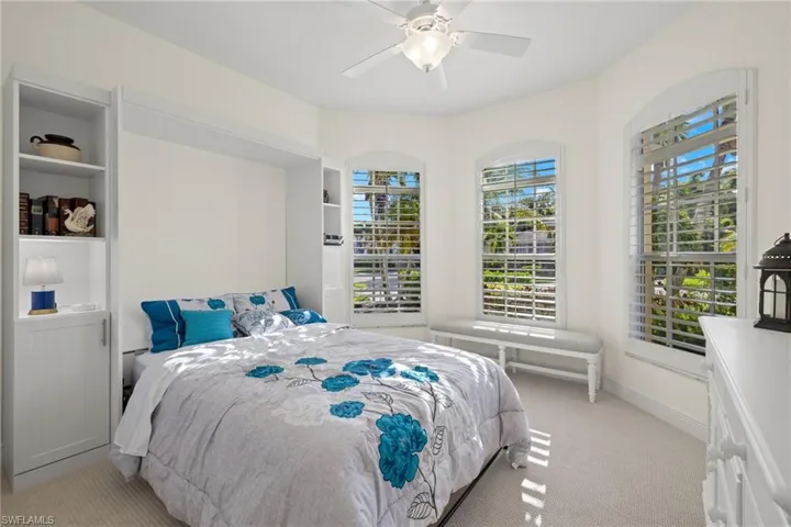 Carpeted bedroom with ceiling fan