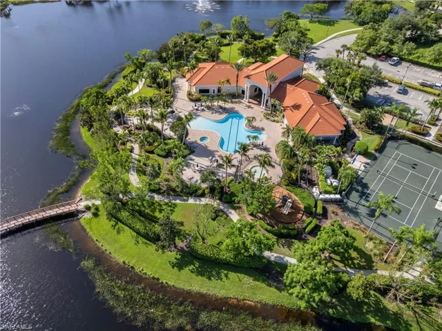 Birds eye view of property with a water view