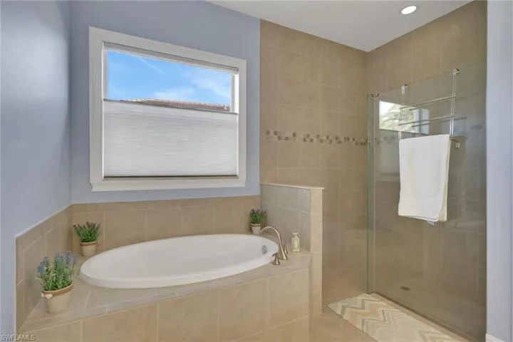 Master bath with separate tub and walk-in shower