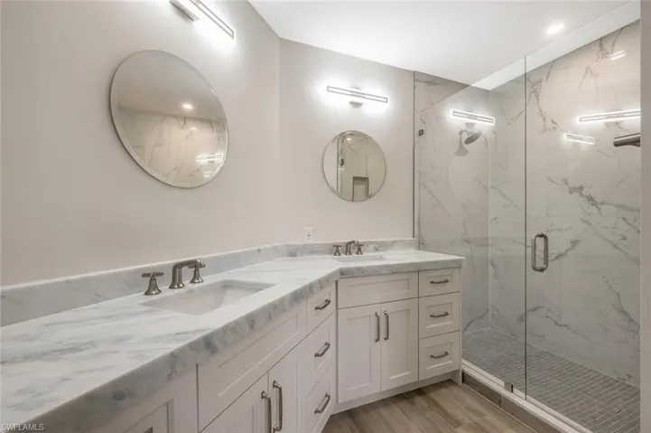 Bathroom featuring vanity, hardwood / wood-style floors, and walk in shower