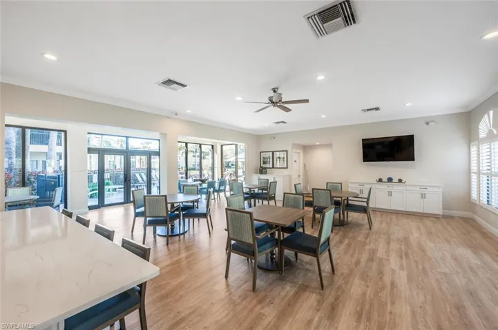 Dining space featuring ornamental molding, ceiling fan, light hardwood / wood-style floors, and french doors