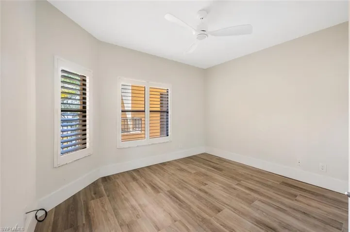 Unfurnished room featuring hardwood / wood-style flooring and ceiling fan