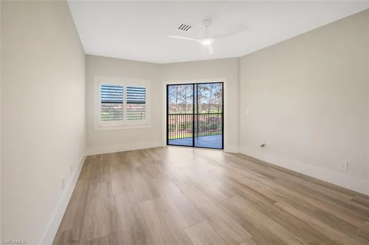 Empty room with ceiling fan and light hardwood / wood-style floors