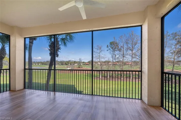 Unfurnished sunroom with ceiling fan