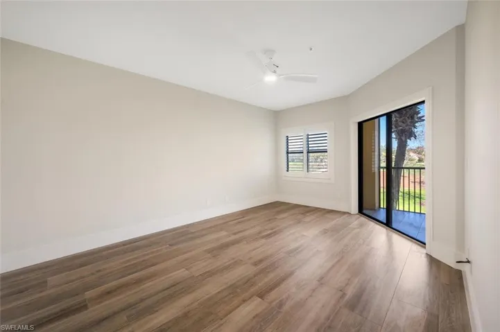 Empty room featuring wood-type flooring and ceiling fan