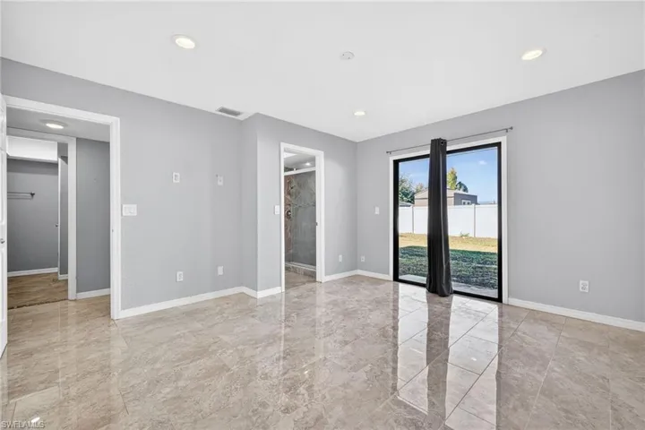 Empty room with recessed lighting and light marble finish flooring