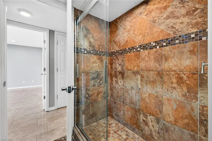 Full bath with a shower stall and recessed lighting