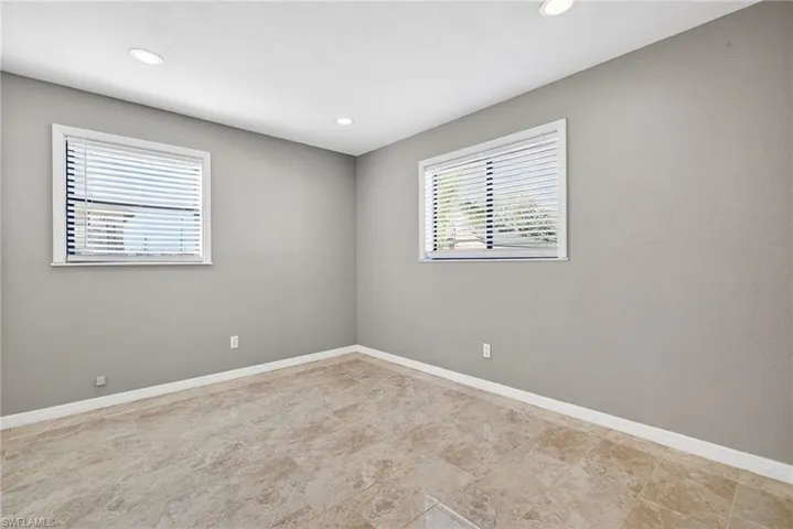 Spare room featuring baseboards and recessed lighting