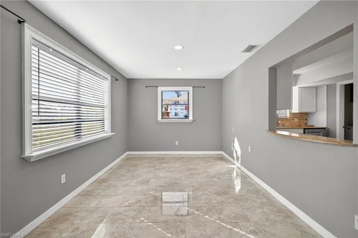 Empty room with recessed lighting and light marble finish floors