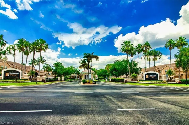 View of asphalt road featuring a residential view and curbs