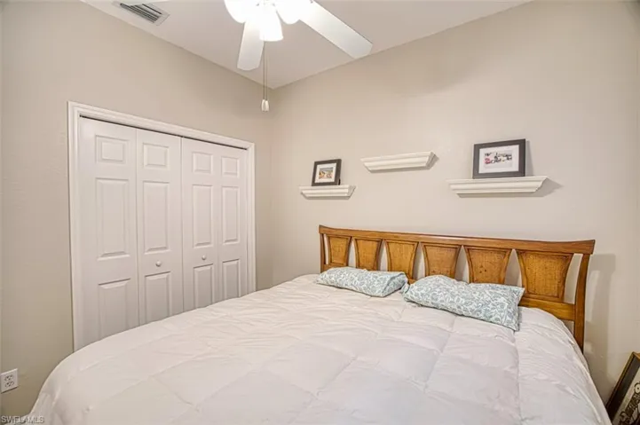 Bedroom with a ceiling fan and a closet