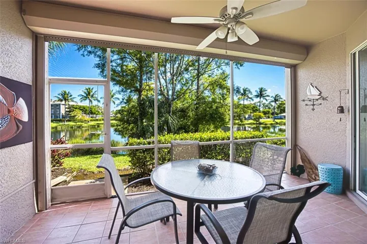 Sunroom / solarium featuring a water view