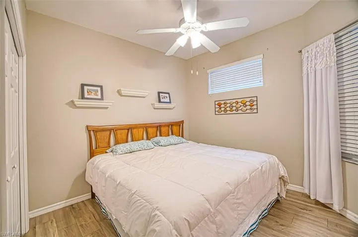 Bedroom featuring a closet, light wood finished floors, and a ceiling fan