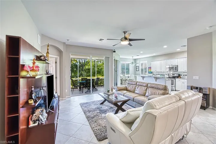 Living area featuring recessed lighting, light tile patterned floors, and a ceiling fan