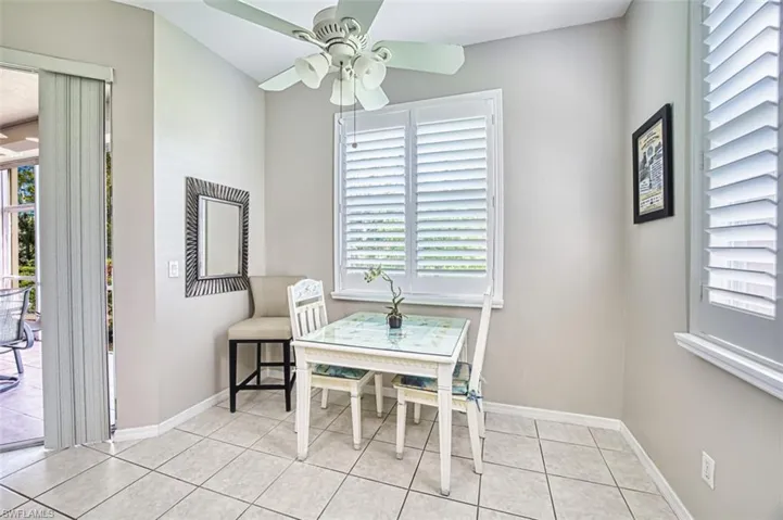Dining area featuring ceiling fan and light tile patterned floors