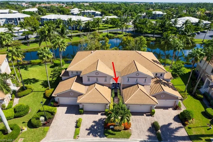 Aerial view of property and surrounding area featuring a large body of water