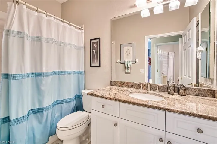 Full bathroom featuring vanity and curtained shower