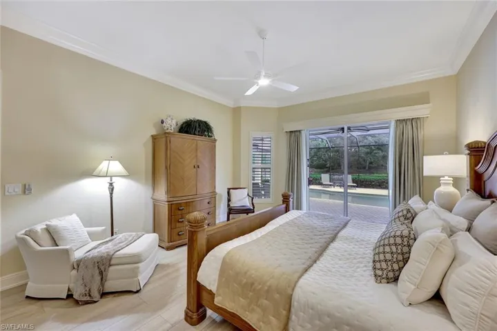 Primary bedroom with sliders to the lanai and two walk in closets
