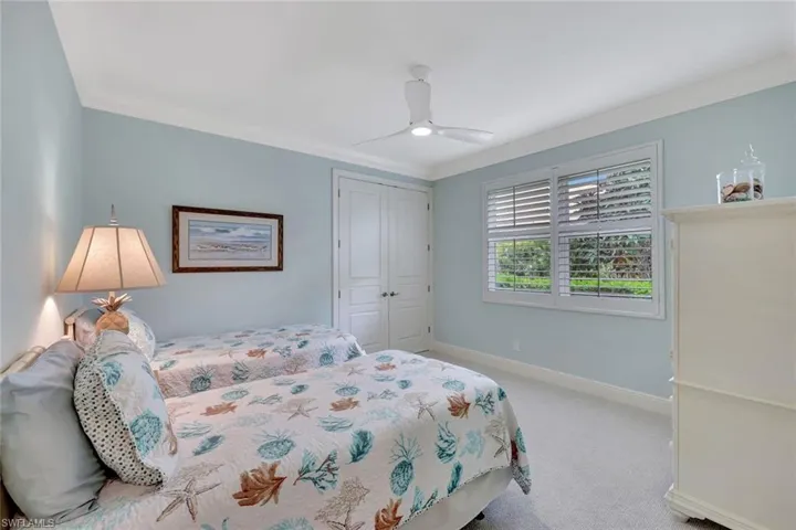 Guest bedroom plantation shutters and large closet