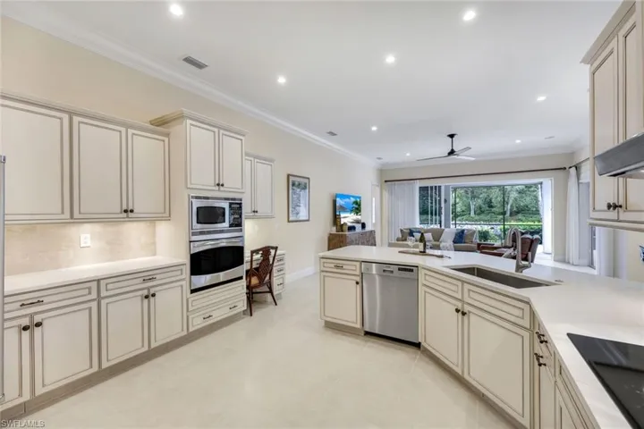 Stainless steel appliances, wall mounted oven and new quartz counter.