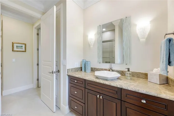 Guest bathroom with updated cabinets, counter, sink and tub with glass sliding doors