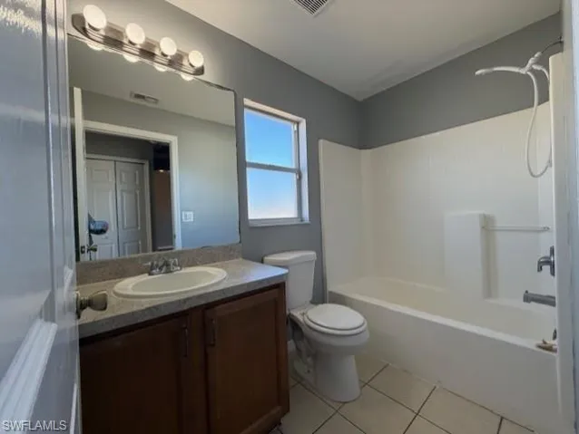 Full bathroom featuring vanity, shower / washtub combination, and light tile patterned floors