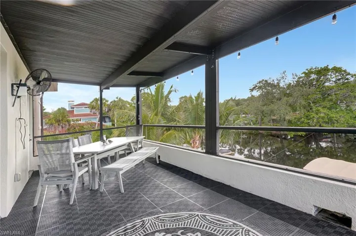 Sunroom featuring outdoor dining space and a balcony