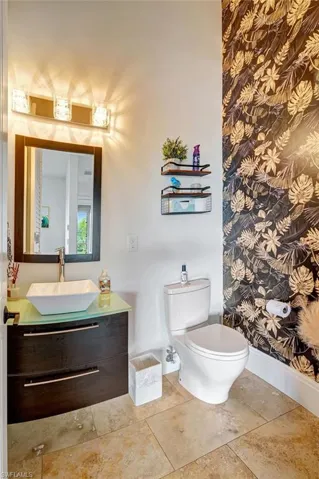 Third floor half bathroom with vanity and toilet