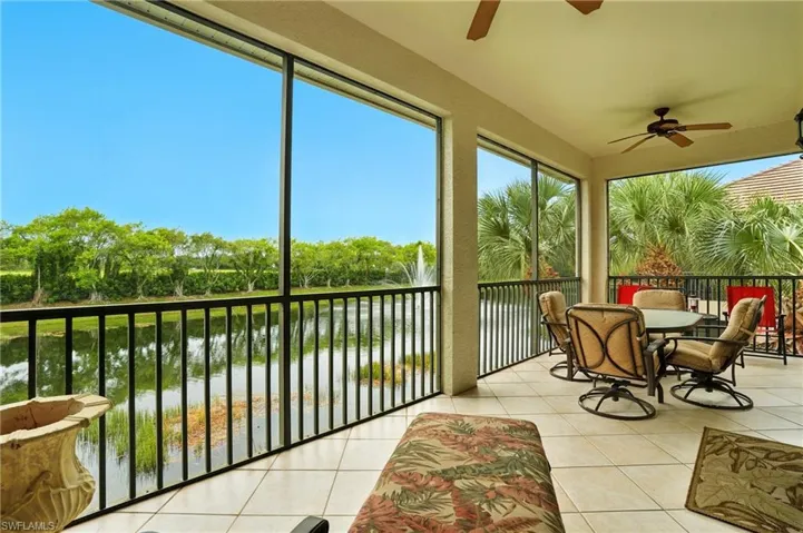 Sunroom / solarium featuring a water view and tile patterned floors