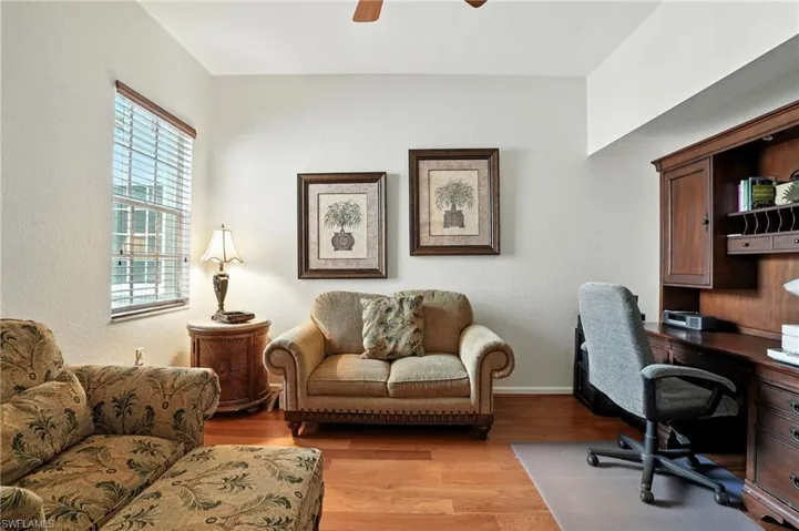 Home office featuring light wood finished floors, a ceiling fan,