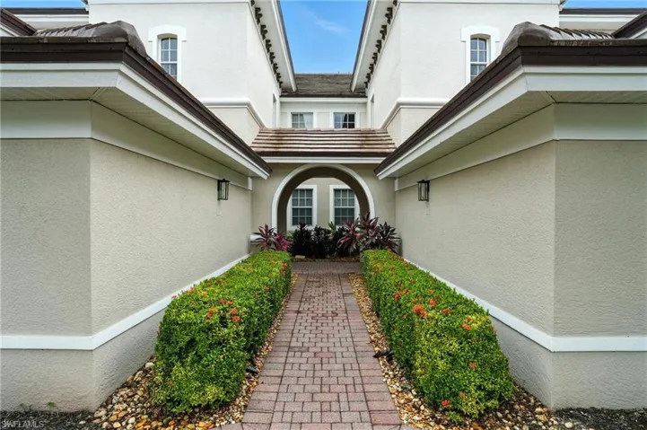Doorway to property featuring stucco siding