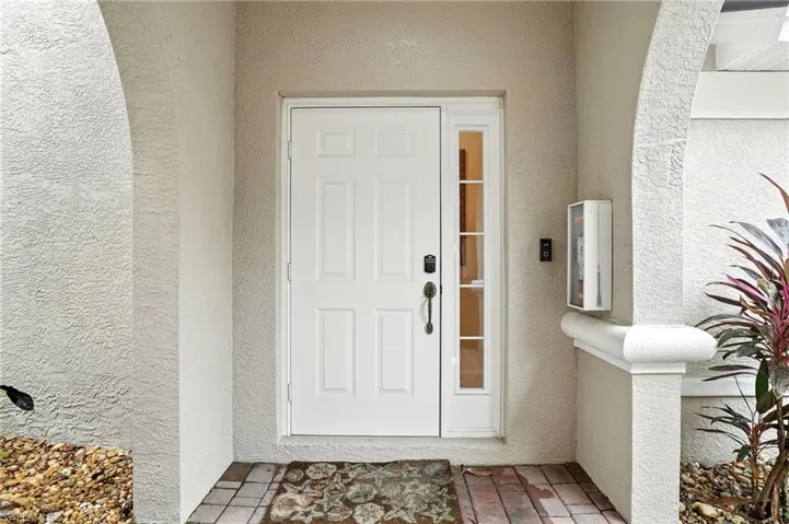 View of exterior entry with stucco siding