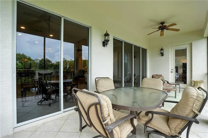 Lanai featuring a ceiling fan, outdoor dining space, and a patio