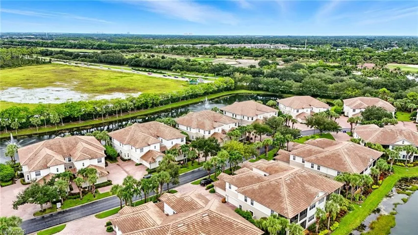 Aerial perspective of suburban area featuring a large body of water