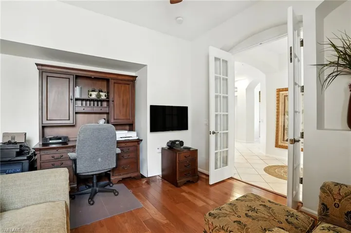 Office featuring french doors, dark wood-type flooring,