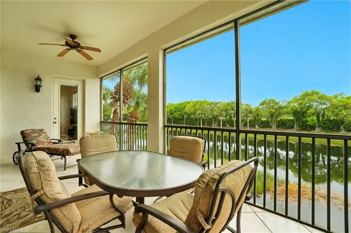 Sunroom / solarium featuring a water view
