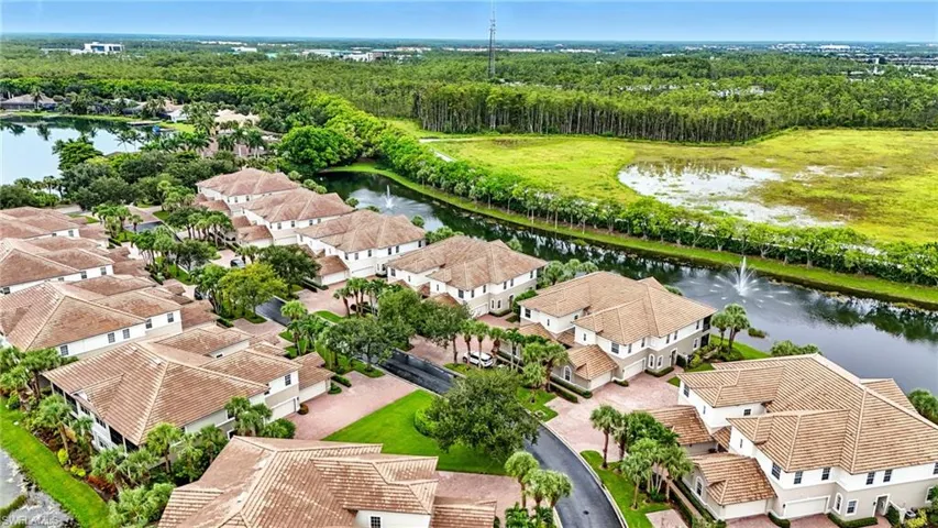Aerial perspective of suburban area featuring a large body of water