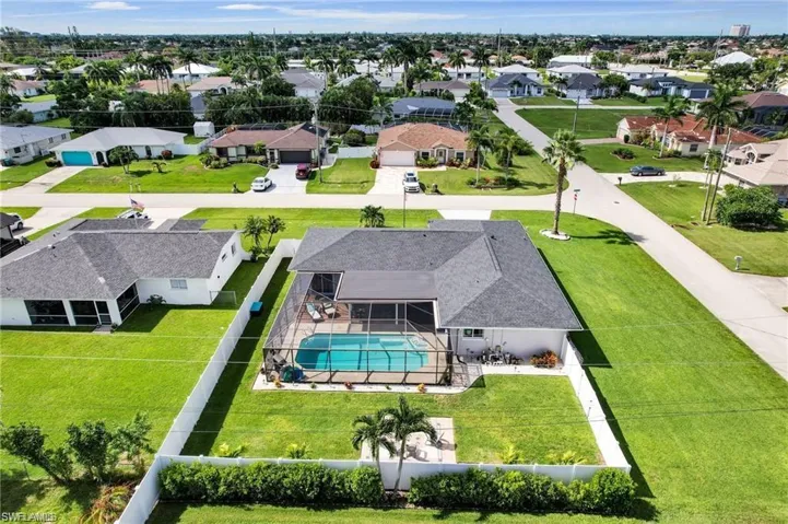 Aerial view of residential area featuring a pool area