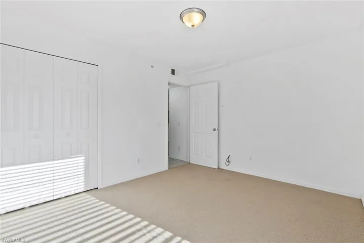 Spare room featuring light carpet