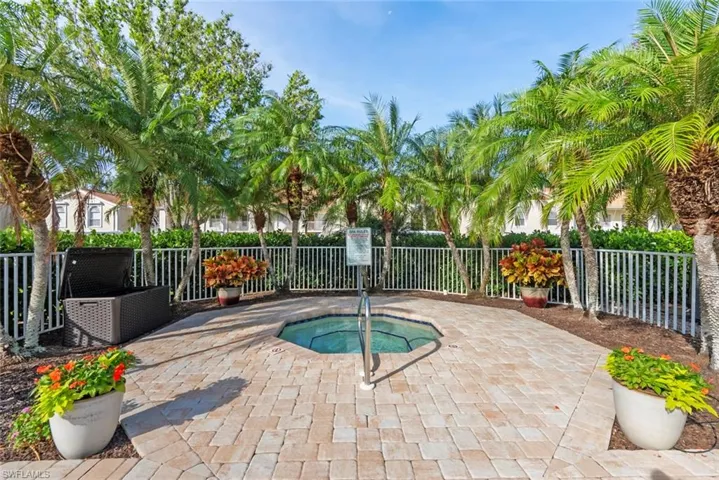 View of swimming pool with a community hot tub and a patio area