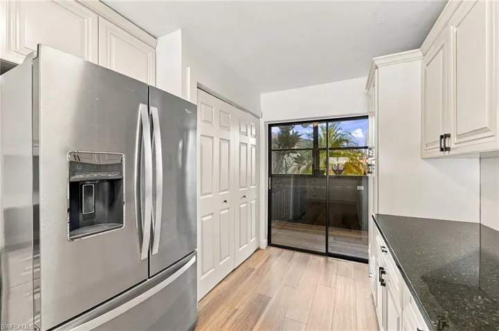 All stainless steel Whirlpool appliances and full size washer & dryer in the closet